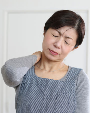 Muscle Sprain Relief - Woman in pain rubbing her neck